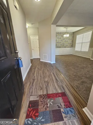 a bedroom with a bed and a rug