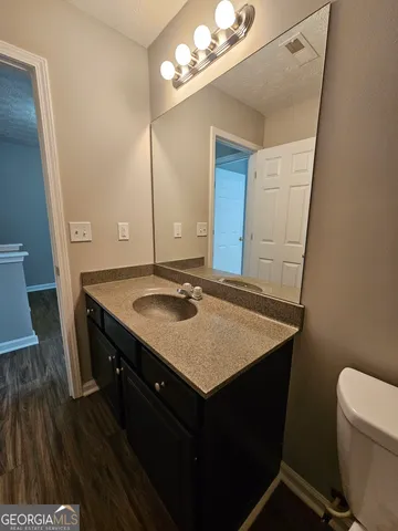 a bathroom with a sink a vanity and a mirror