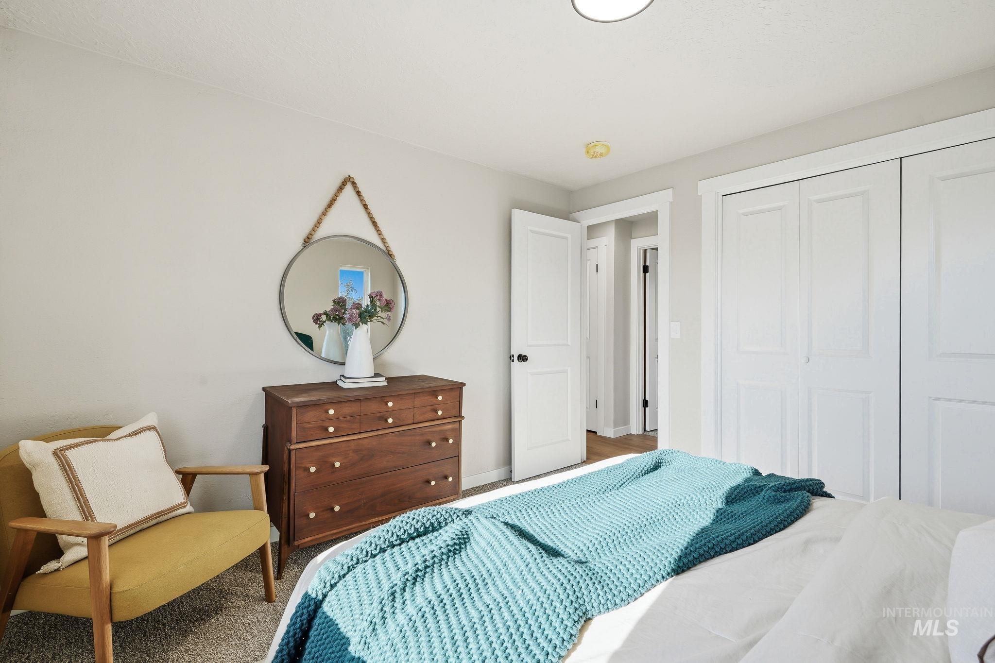 1990 Panama Street Boise, ID 83705 - Photo 33 of 50 Bright bedroom featuring light gray walls, white trim, and a textured carpet