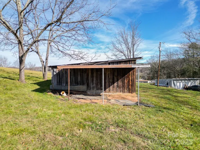 a view of a house with backyard and trees