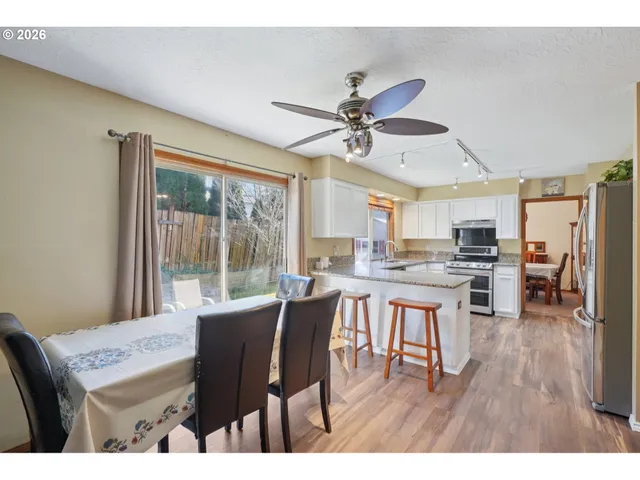 a dining room with furniture window and wooden floor