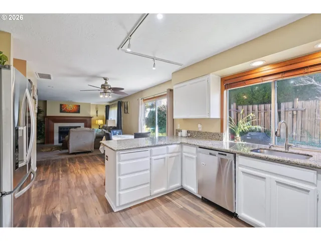a kitchen with sink refrigerator and window