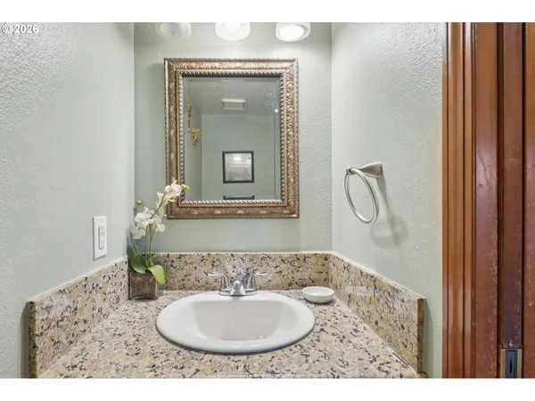 a bathroom with a sink a mirror and a shower