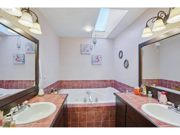 a bathroom with a granite countertop sink mirror and vanity