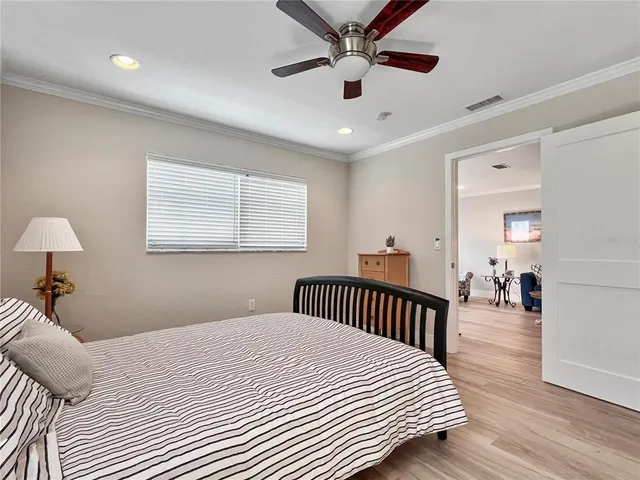 a bedroom with bed and wooden floor