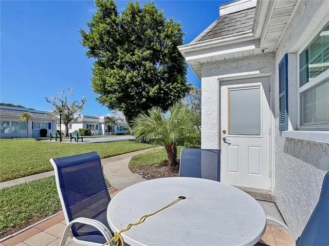 a view of backyard with seating area and green space