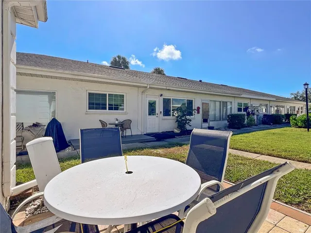 a view of a dining room with furniture a rug and wooden floor