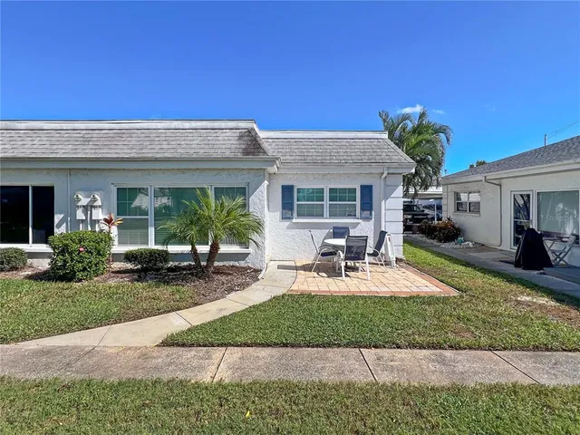 a house view with a seating space and garden