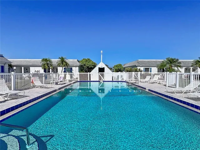 a view of a house with backyard porch and sitting area