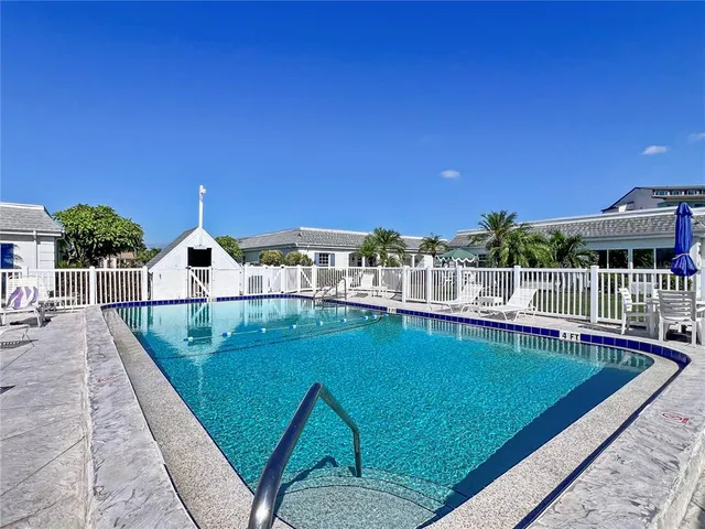 a view of a swimming pool with a lounge chair