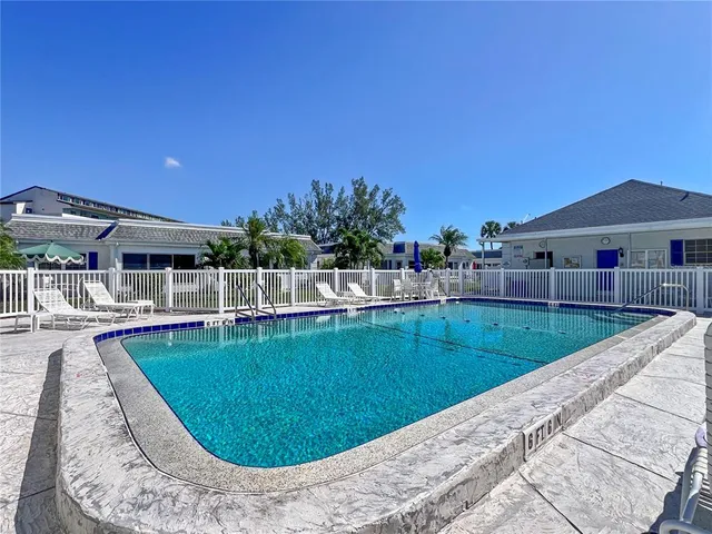 a view of a swimming pool with chairs