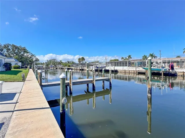 a view of a lake with a table and chairs