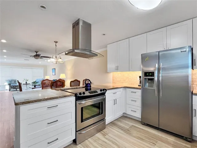 a kitchen with granite countertop a stove oven and cabinets