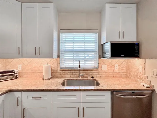 a kitchen with a sink and cabinets