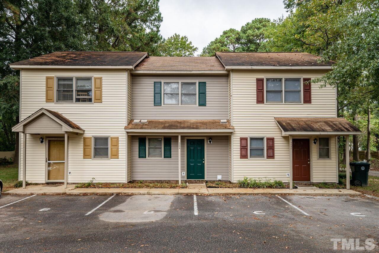 a front view of a house with a yard and a garage
