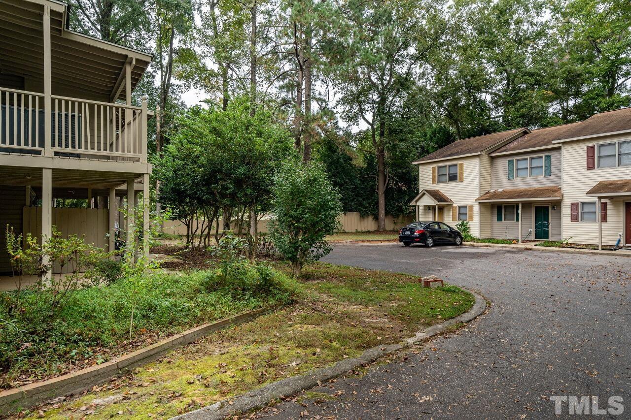 500 Forest Drive Garner, NC 27529 - Photo 9 of 9 a view of a white house with a yard plants and large tree
