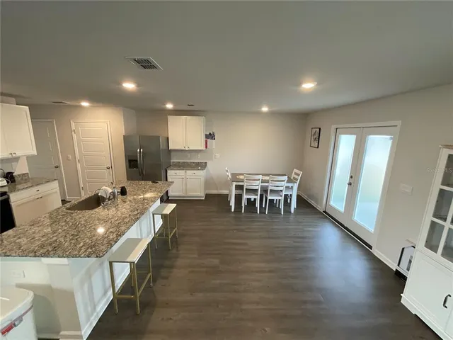 a large kitchen with lots of counter space and a dining table