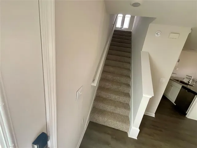 a view of staircase with wooden floor and entryway