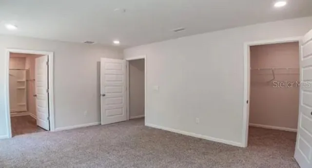 a view of an empty room with closet area