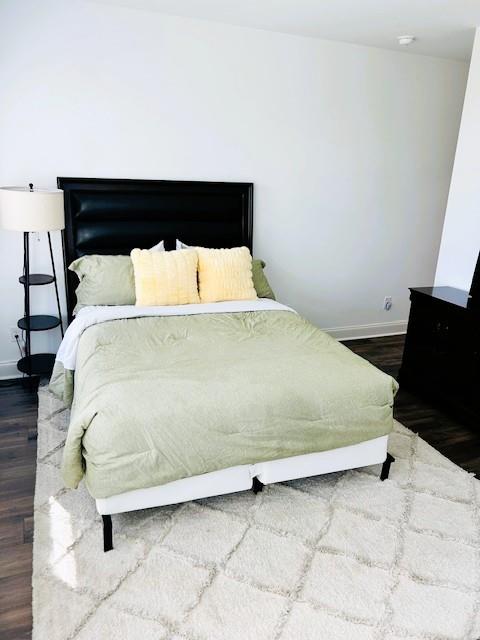 5236 Riden Court Buford, GA 30518 - Photo 23 of 41 a bed sitting in a bedroom next to a window with potted plants on a stool
