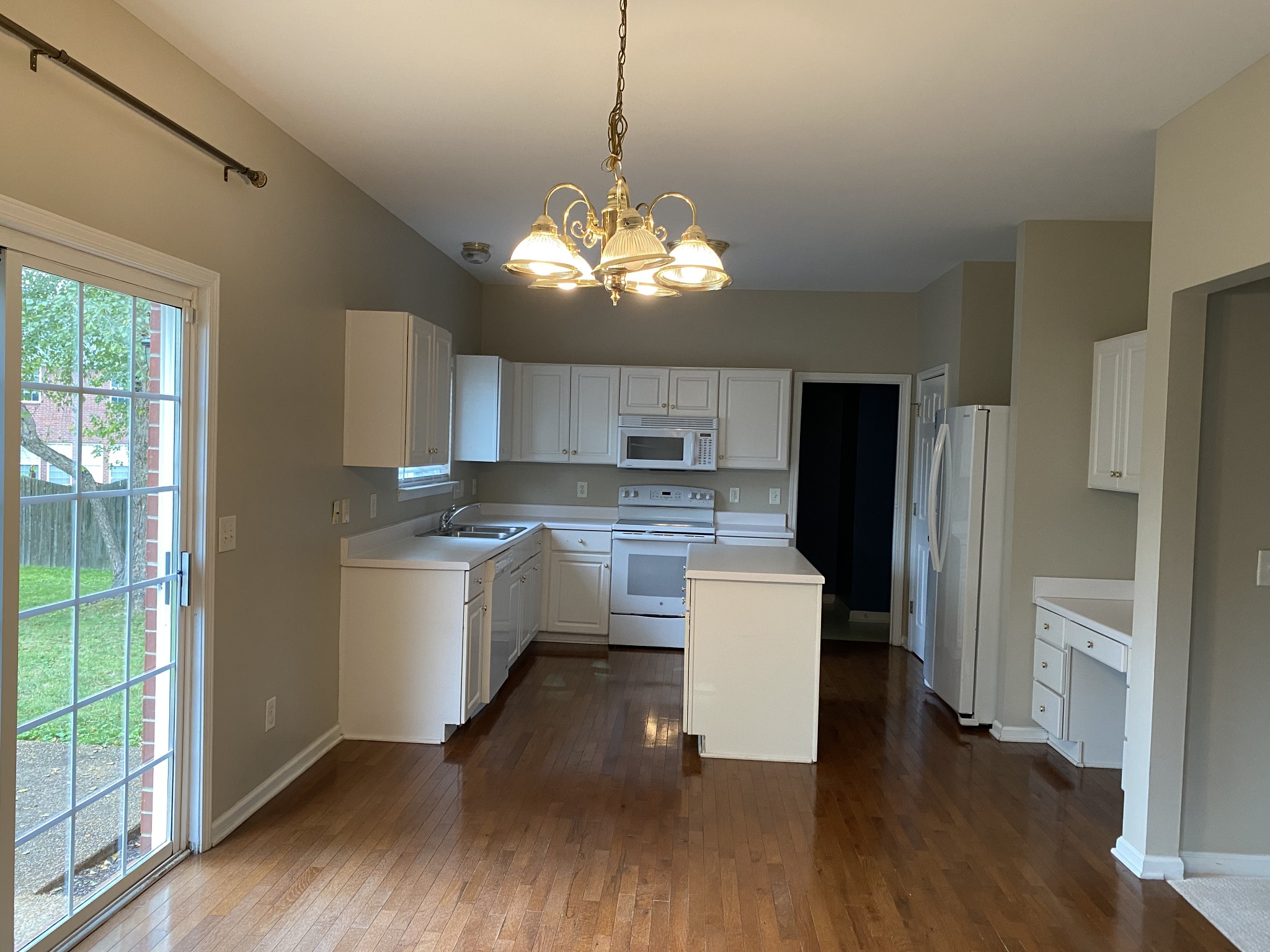 1302 Fenner Court Franklin, TN 37067 - Photo 7 of 26 a kitchen with a chandelier and wooden floor