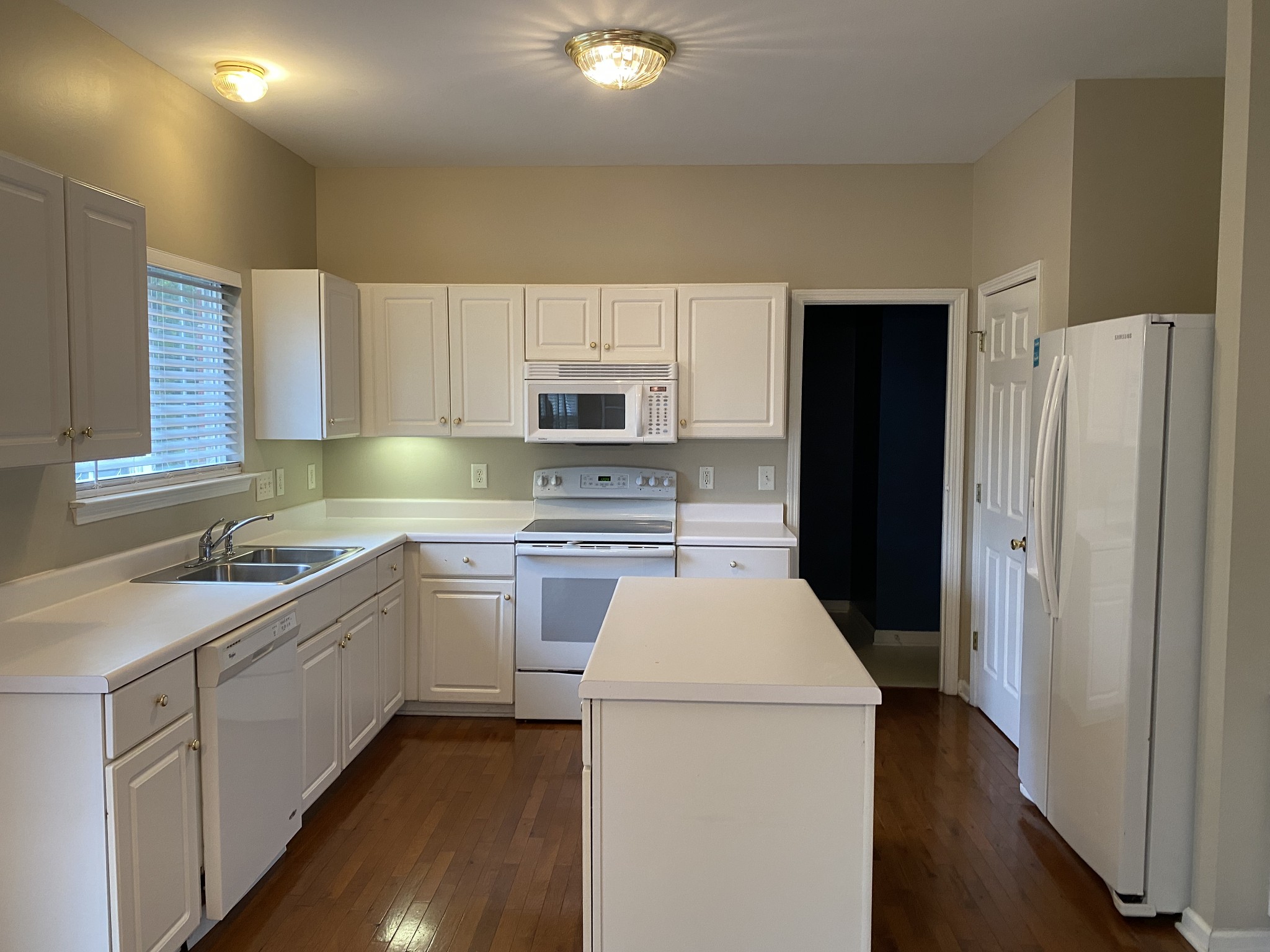 1302 Fenner Court Franklin, TN 37067 - Photo 9 of 26 a kitchen with a sink a stove a refrigerator and cabinets