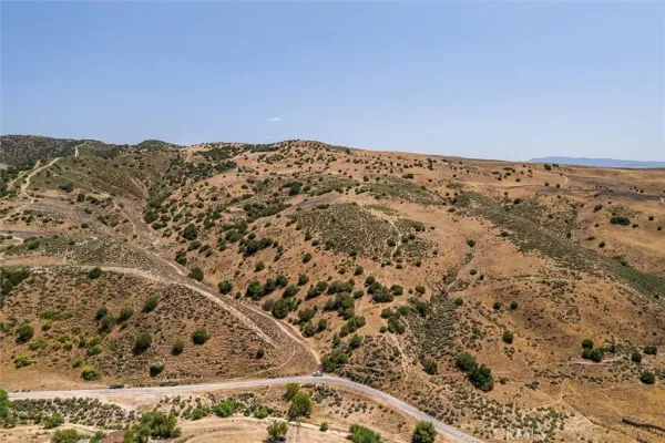 a view of a large mountain with a mountain in the background