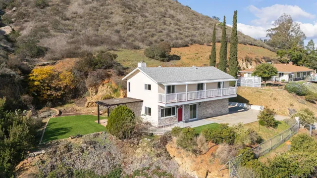 a aerial view of a house with a yard