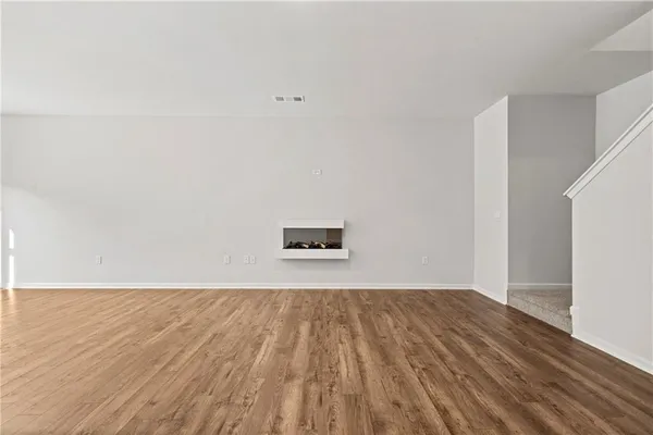 a view of a room with wooden floor