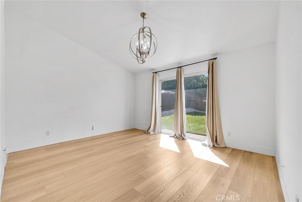 24461 Willow Run Road Moreno Valley, CA 92557 - Photo 12 of 24 a view of an empty room with wooden floor and window
