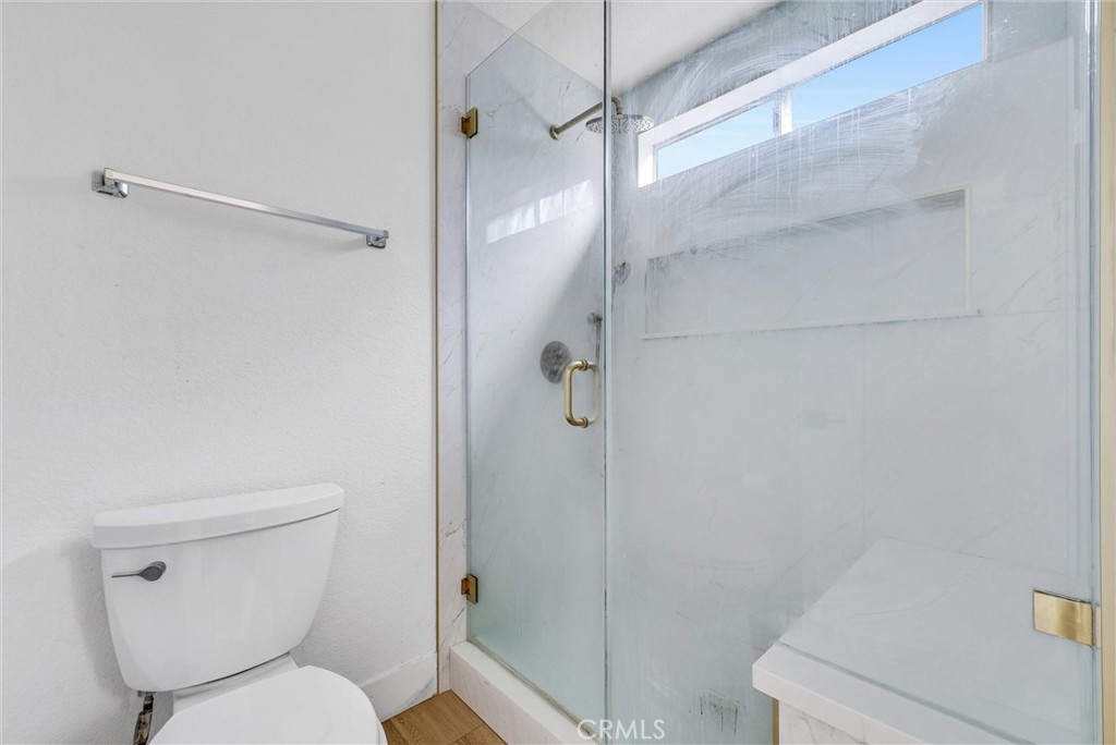 24461 Willow Run Road Moreno Valley, CA 92557 - Photo 16 of 24 a white toilet sitting next to a bath tub