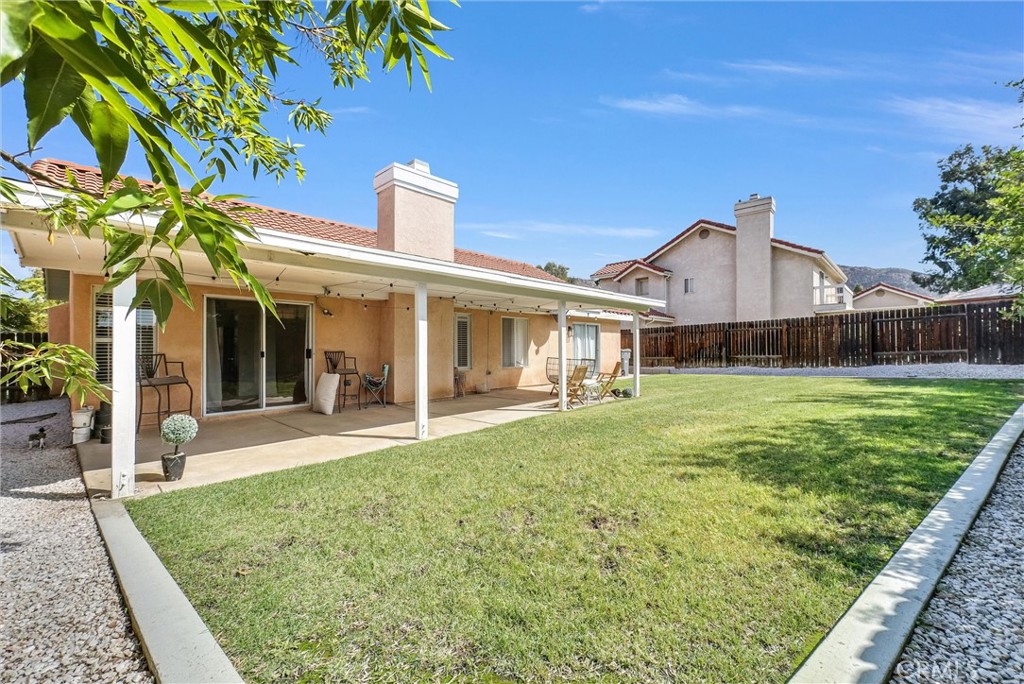 24461 Willow Run Road Moreno Valley, CA 92557 - Photo 20 of 24 a front view of a house with a garden and yard