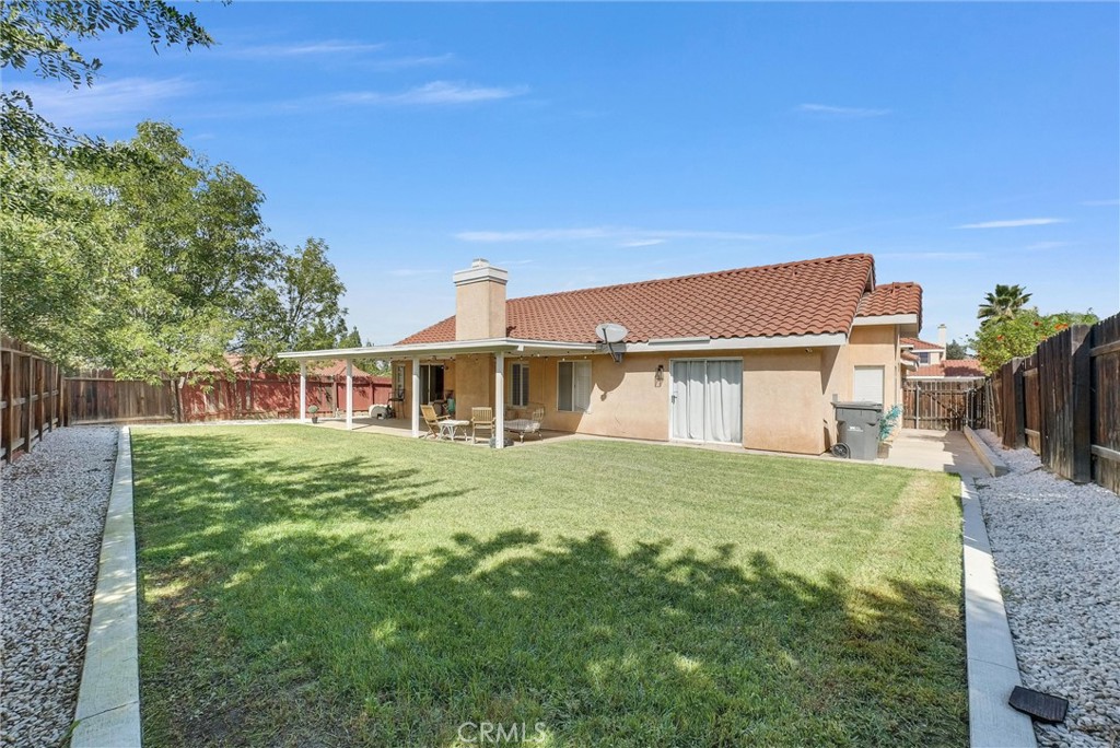 24461 Willow Run Road Moreno Valley, CA 92557 - Photo 21 of 24 a front view of a house with a garden
