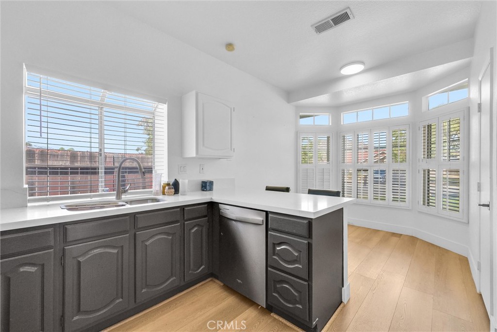 24461 Willow Run Road Moreno Valley, CA 92557 - Photo 6 of 24 a kitchen with a sink stove and cabinets