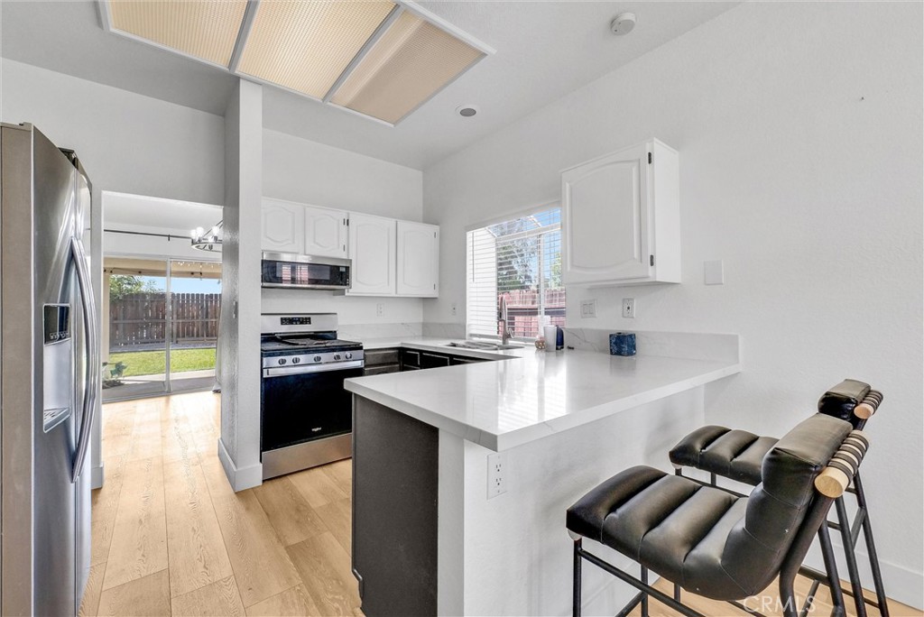24461 Willow Run Road Moreno Valley, CA 92557 - Photo 9 of 24 a kitchen with a sink appliances and cabinets