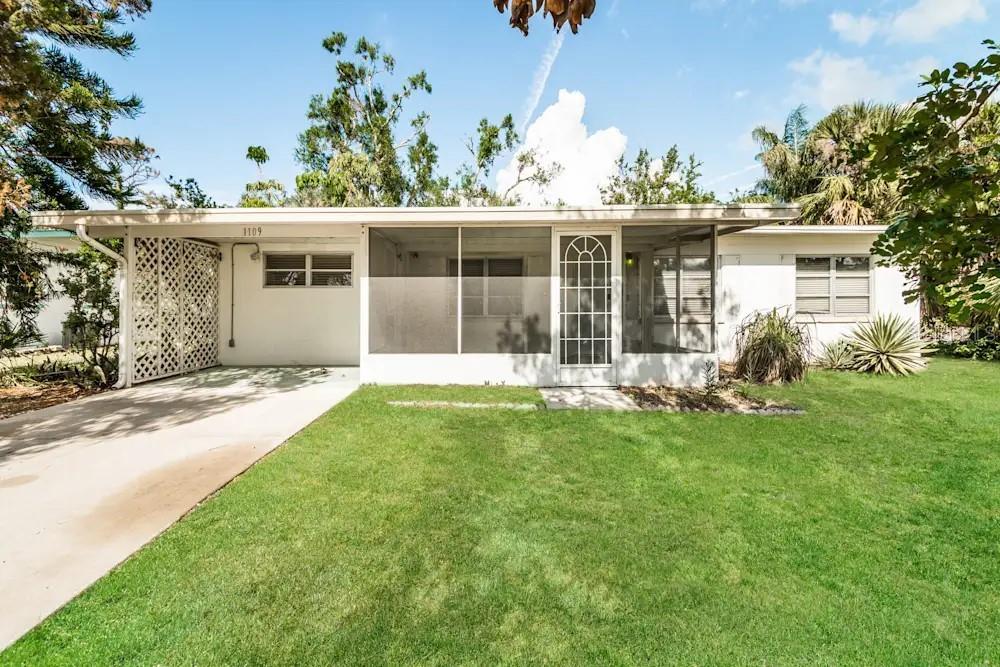 1109 Myrtle Avenue Venice, FL 34285 - Photo 1 of 15 front view of a house with a yard