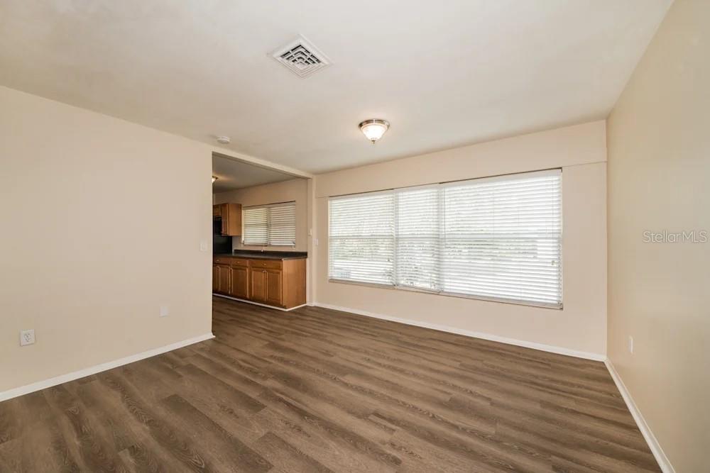 1109 Myrtle Avenue Venice, FL 34285 - Photo 11 of 15 an empty room with wooden floor cabinet and windows