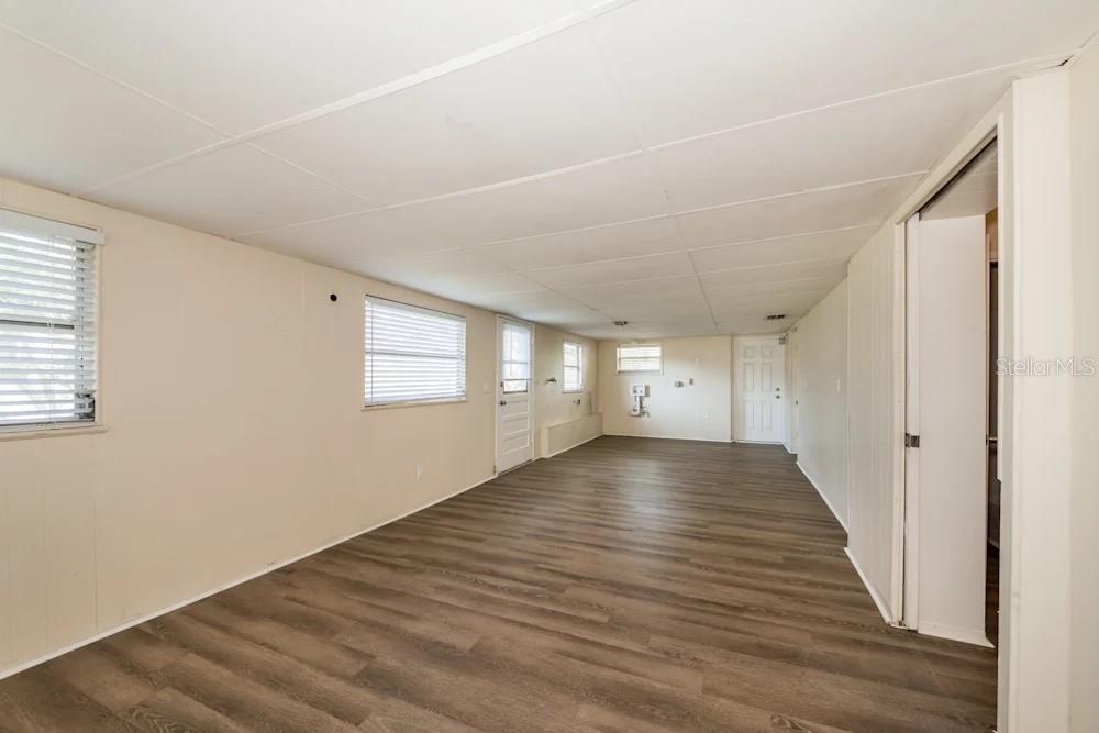 1109 Myrtle Avenue Venice, FL 34285 - Photo 7 of 15 a view of an empty room with wooden floor and a window