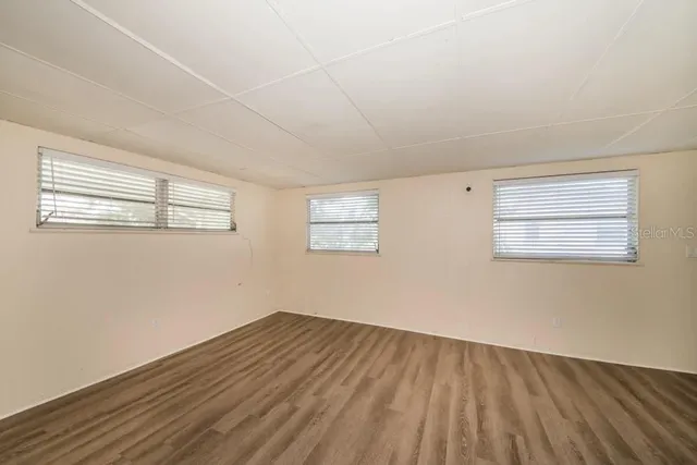 a view of a room with wooden floor and windows
