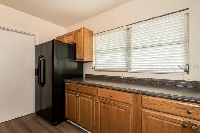a kitchen with stainless steel appliances granite countertop a refrigerator and a sink