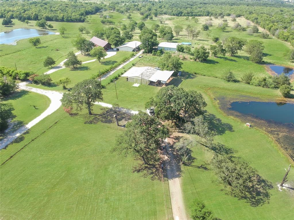 1001 Sandy Ridge Road Scurry, TX 75158 - Photo 4 of 35 Expansive property featuring verdant green acreage, multiple buildings, and two ponds