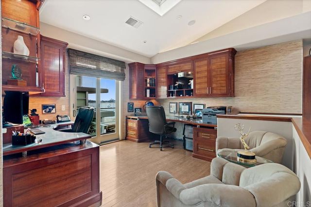 a bedroom with a large bed and a chandelier fan