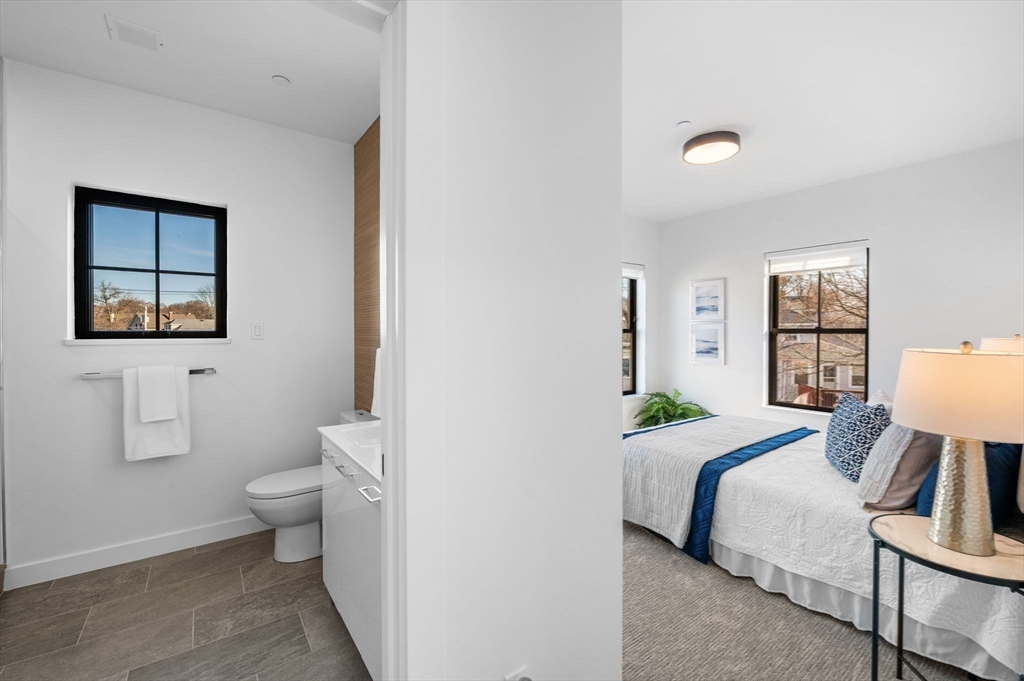 11 Boynton Street, Unit 204 Swampscott, MA 01907 - Photo 24 of 42 a bedroom with a bed and wooden floor