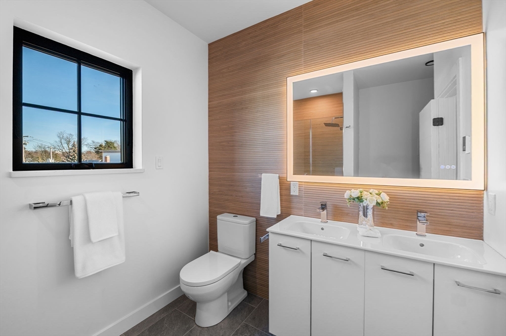 11 Boynton Street, Unit 204 Swampscott, MA 01907 - Photo 27 of 42 a bathroom with a toilet sink and mirror