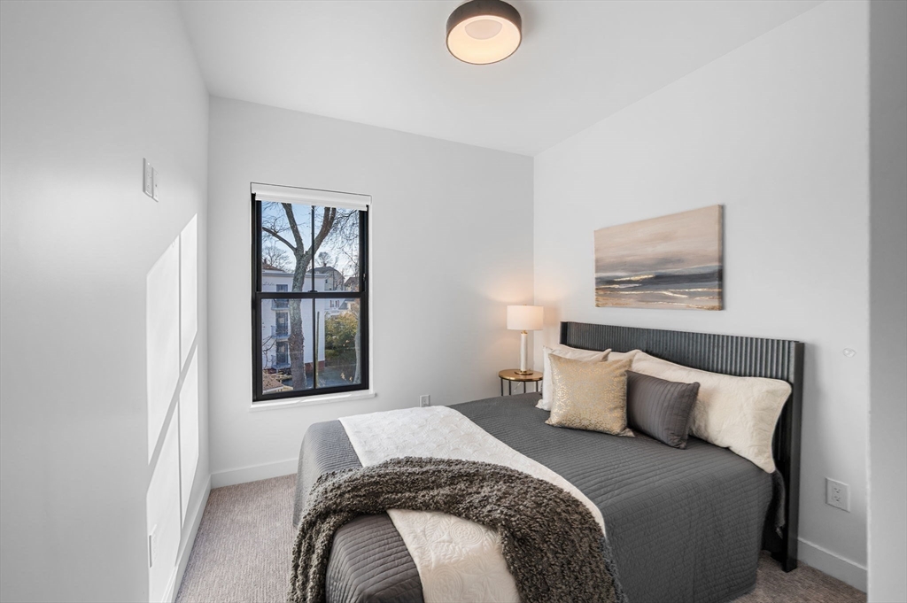 11 Boynton Street, Unit 204 Swampscott, MA 01907 - Photo 30 of 42 a bedroom with a bed and a window
