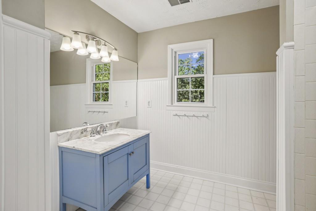 4972 Vermack Road Atlanta, GA 30338 - Photo 18 of 46 a bathroom with a sink a mirror and a window