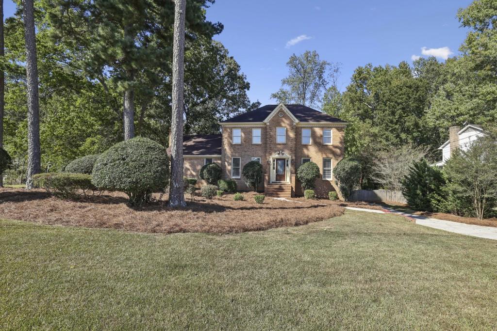4972 Vermack Road Atlanta, GA 30338 - Photo 26 of 46 a front view of a house with a yard and garage