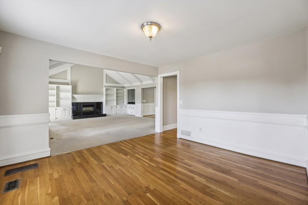 4972 Vermack Road Atlanta, GA 30338 - Photo 4 of 46 a view of empty room with wooden floor and fireplace