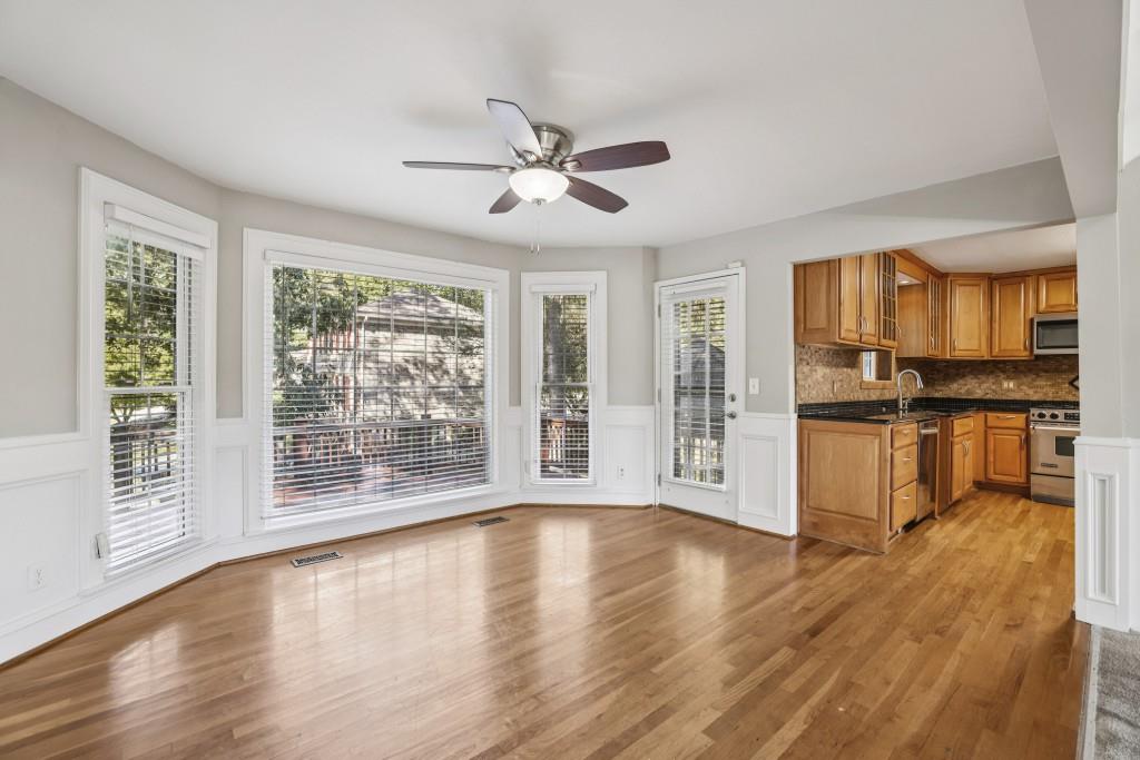 4972 Vermack Road Atlanta, GA 30338 - Photo 7 of 46 a view of an empty room with wooden floor and a kitchen