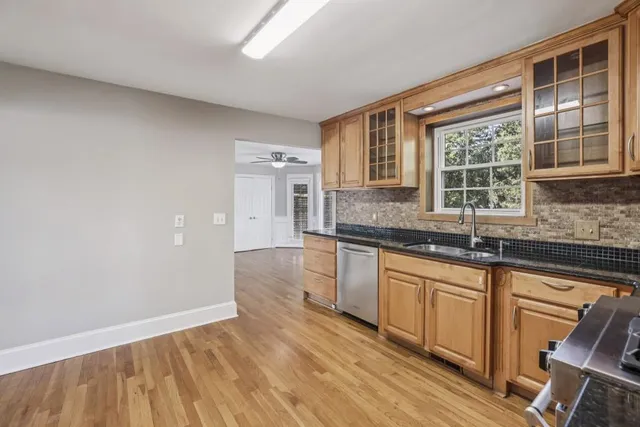 a kitchen with granite countertop a sink and a stove